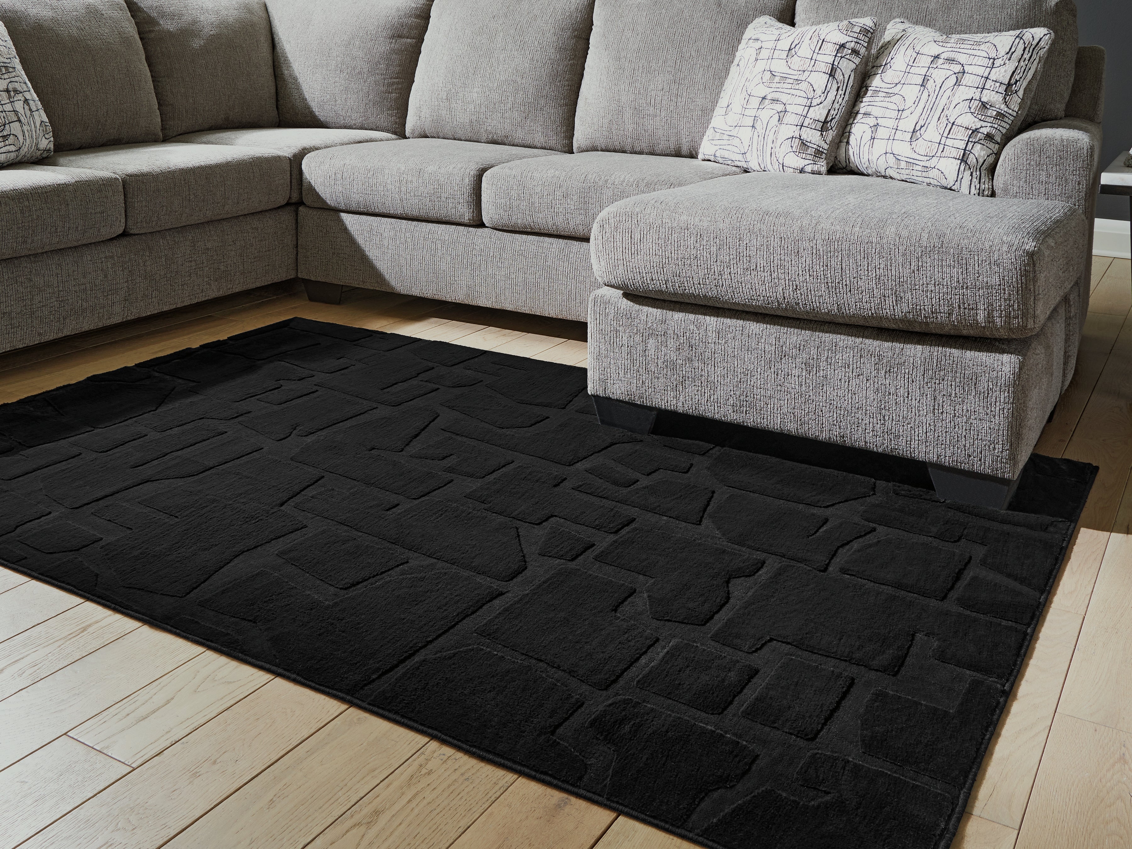Best Furniture Outlet - Ashley Furniture - Gibbswell Rug - Washable 5' x 7' Area Rug / Black - R407462